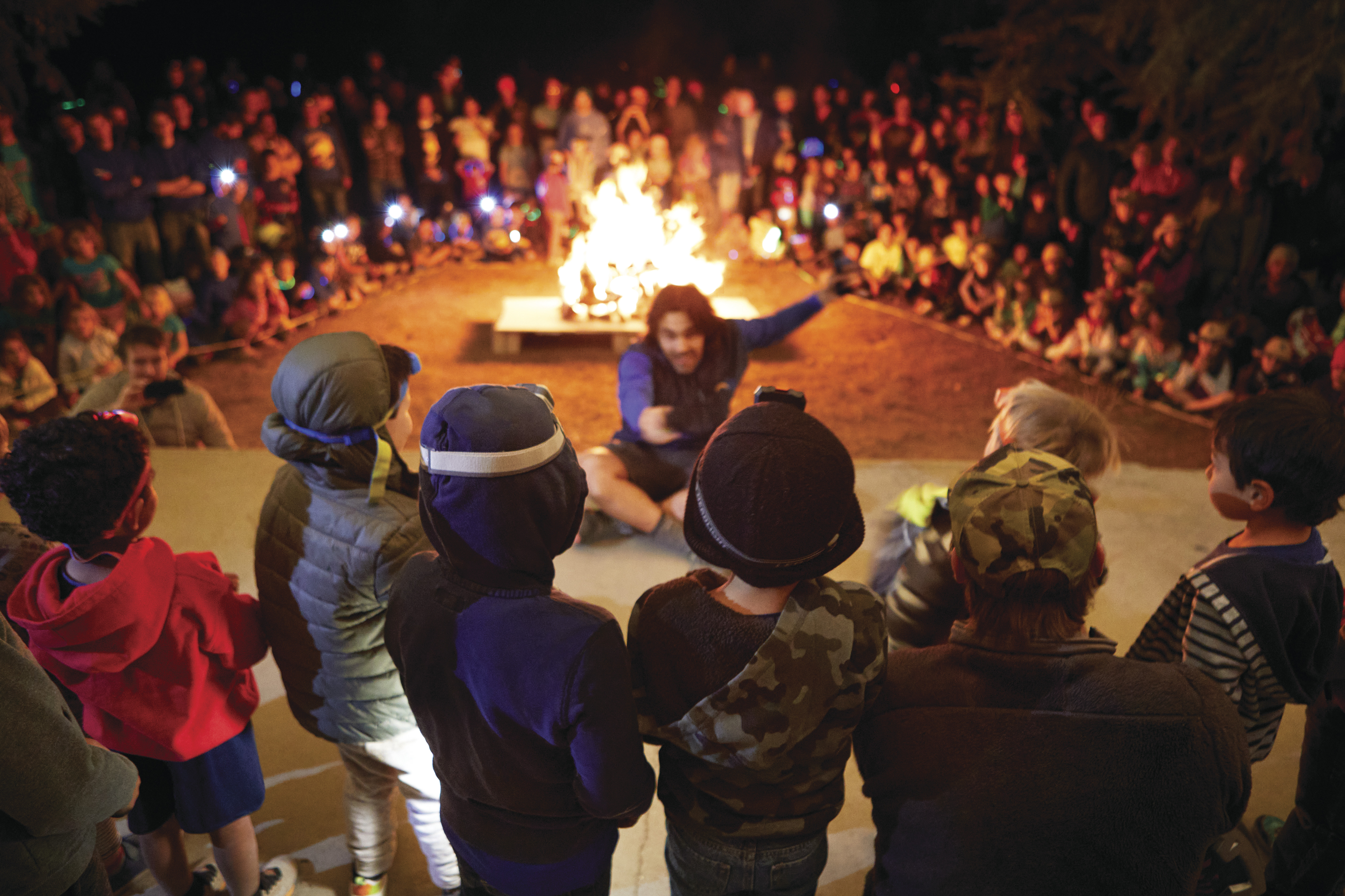 Large group of children around the campfire