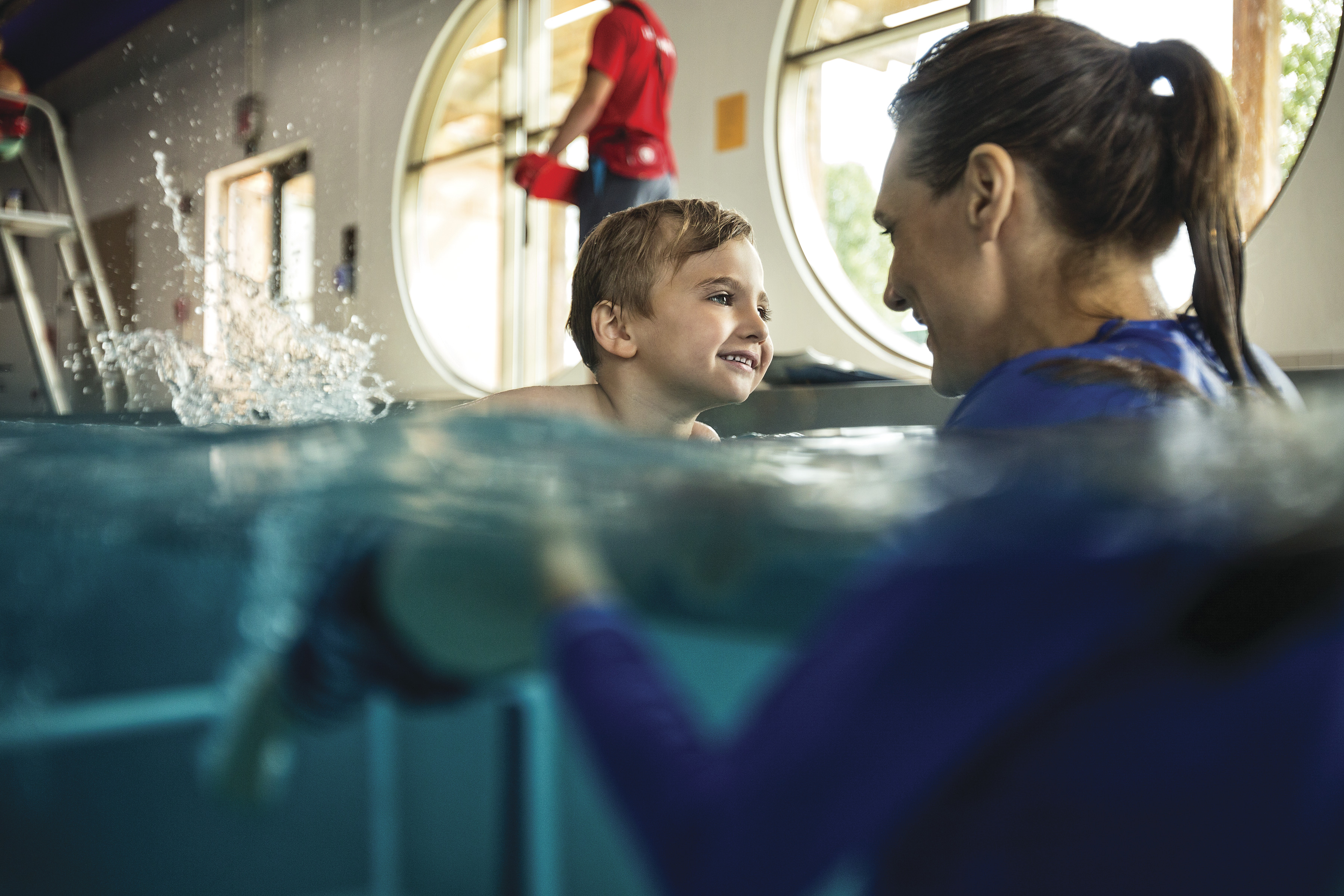 Child and guardian practice water safety during swim classes at YMCA Child and guardian practice water safety during swim classes at YMCA