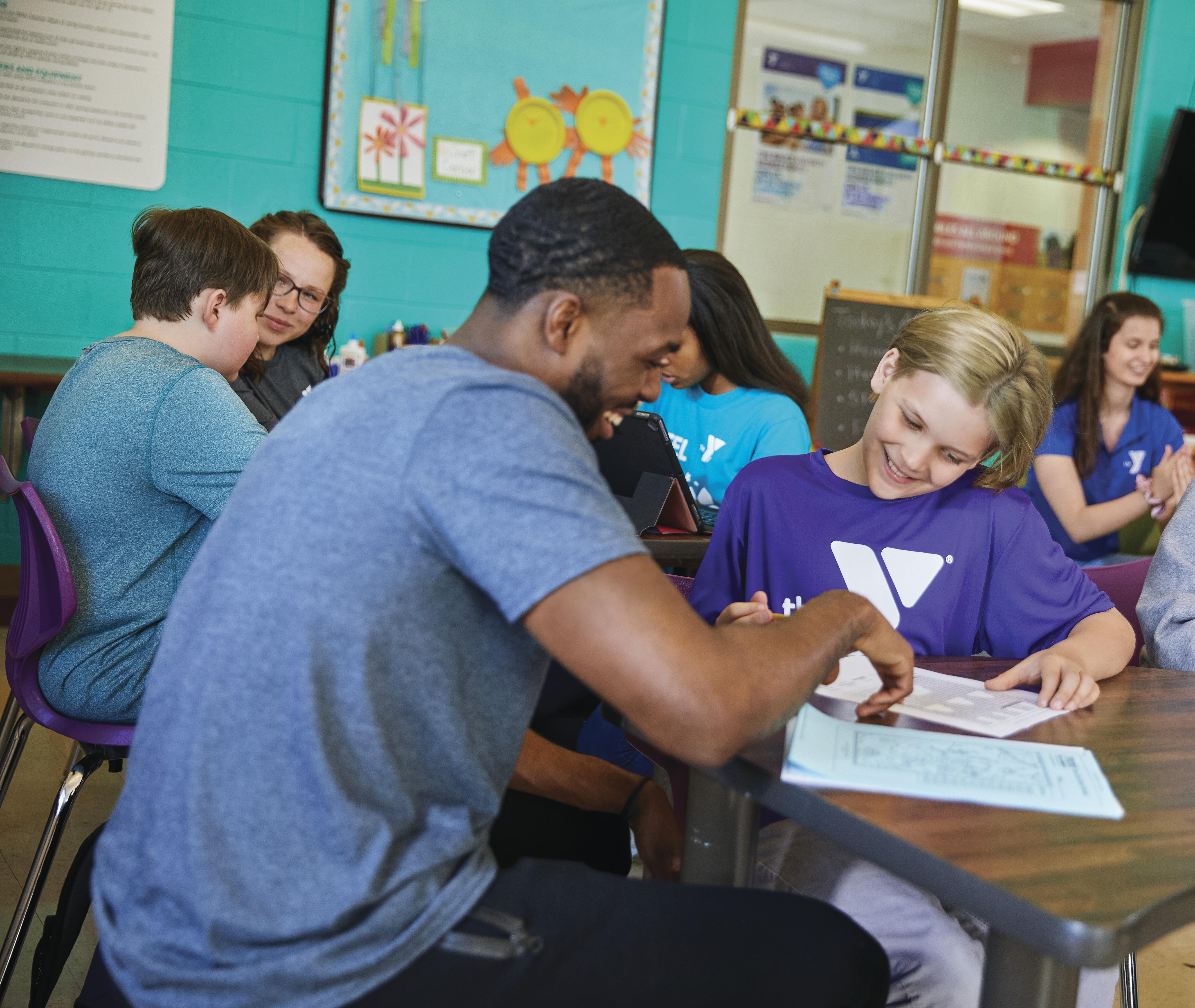 Student working with staff at Y afterschool program