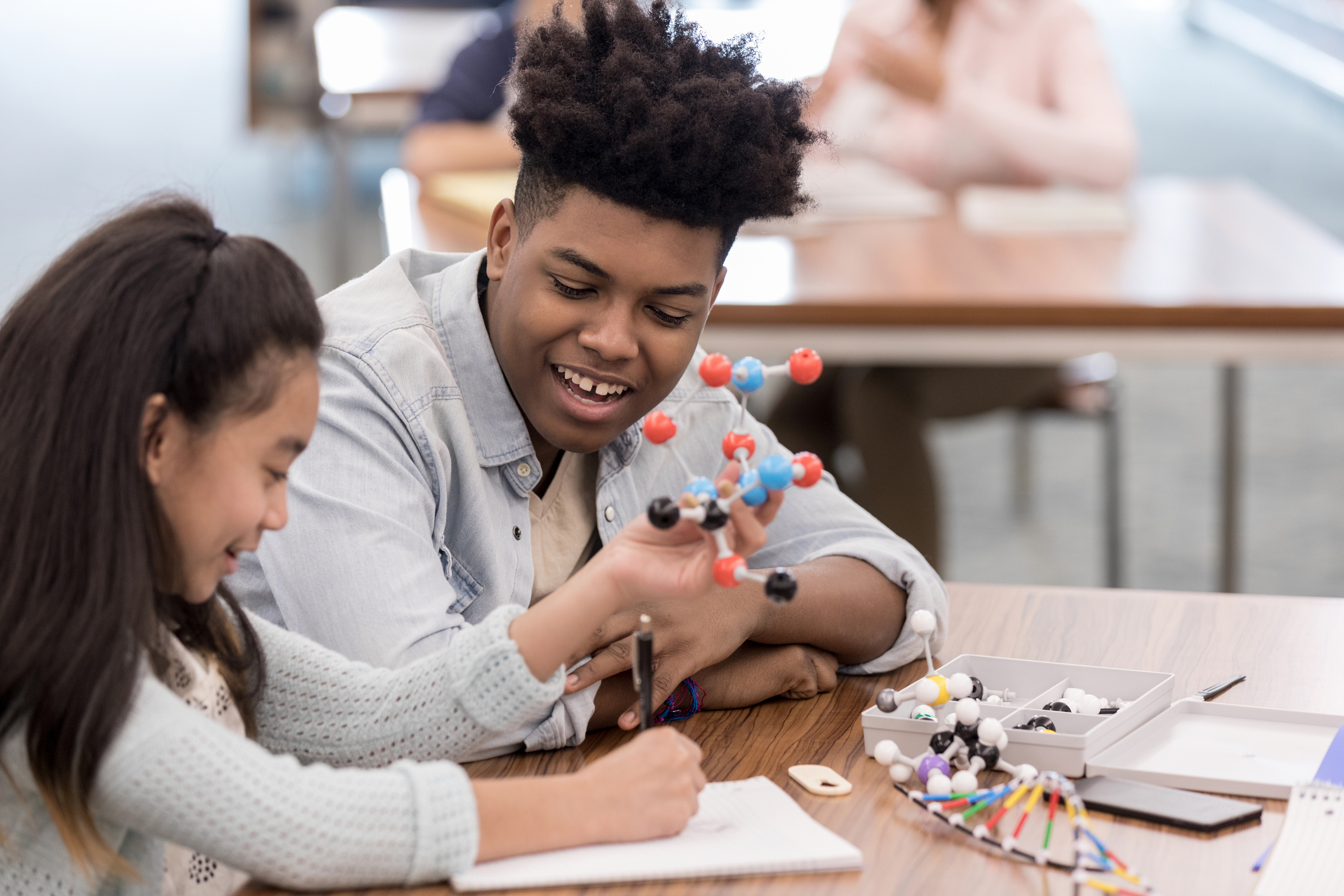 Teen helping tutor a child