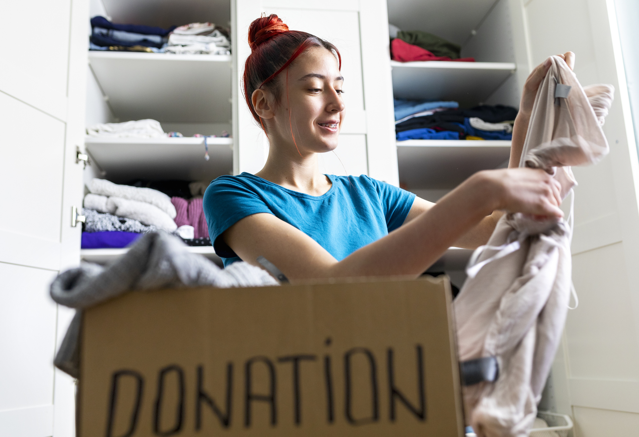 Teen girl donating clothes