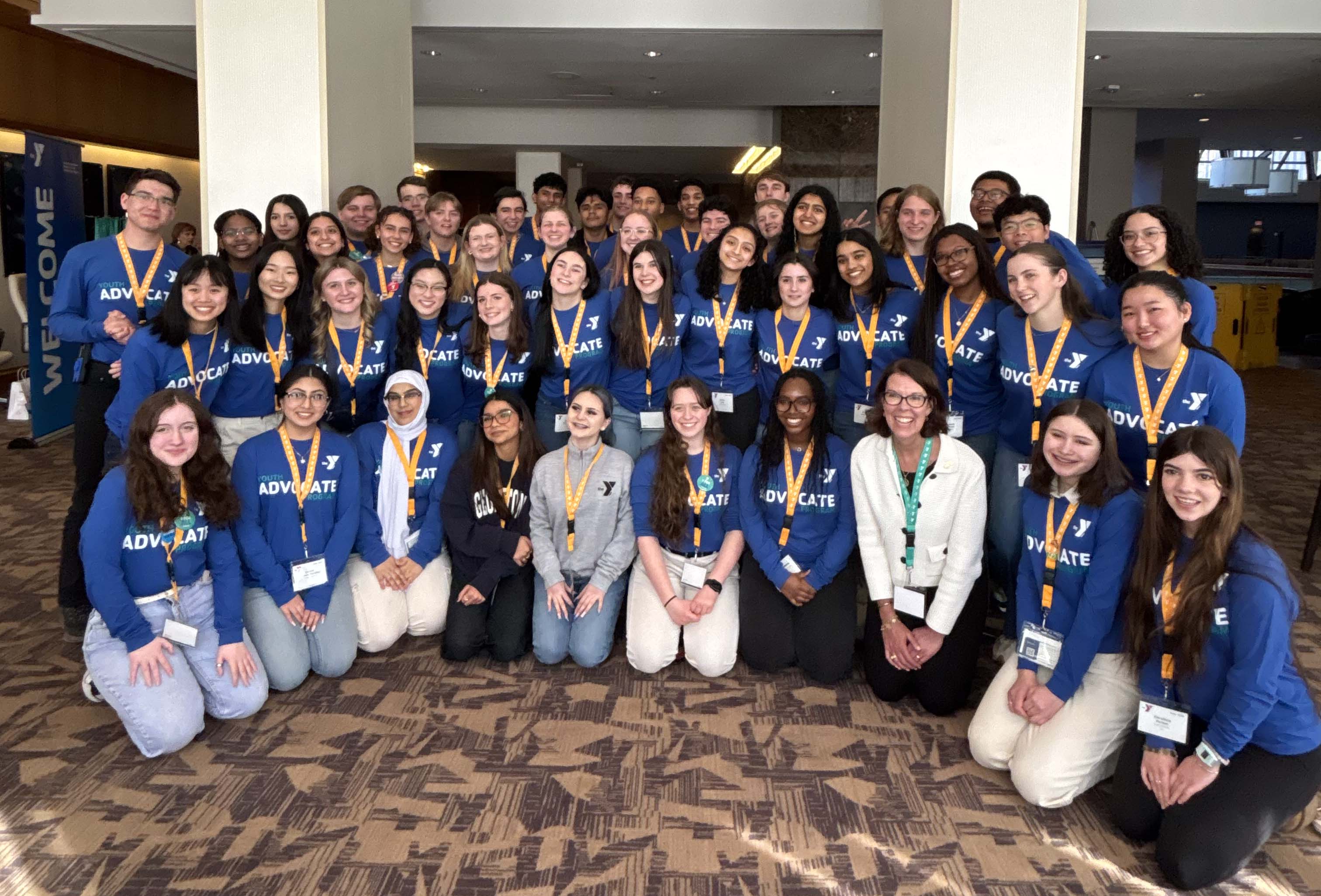 YMCA president and CEO posing with youth advocates