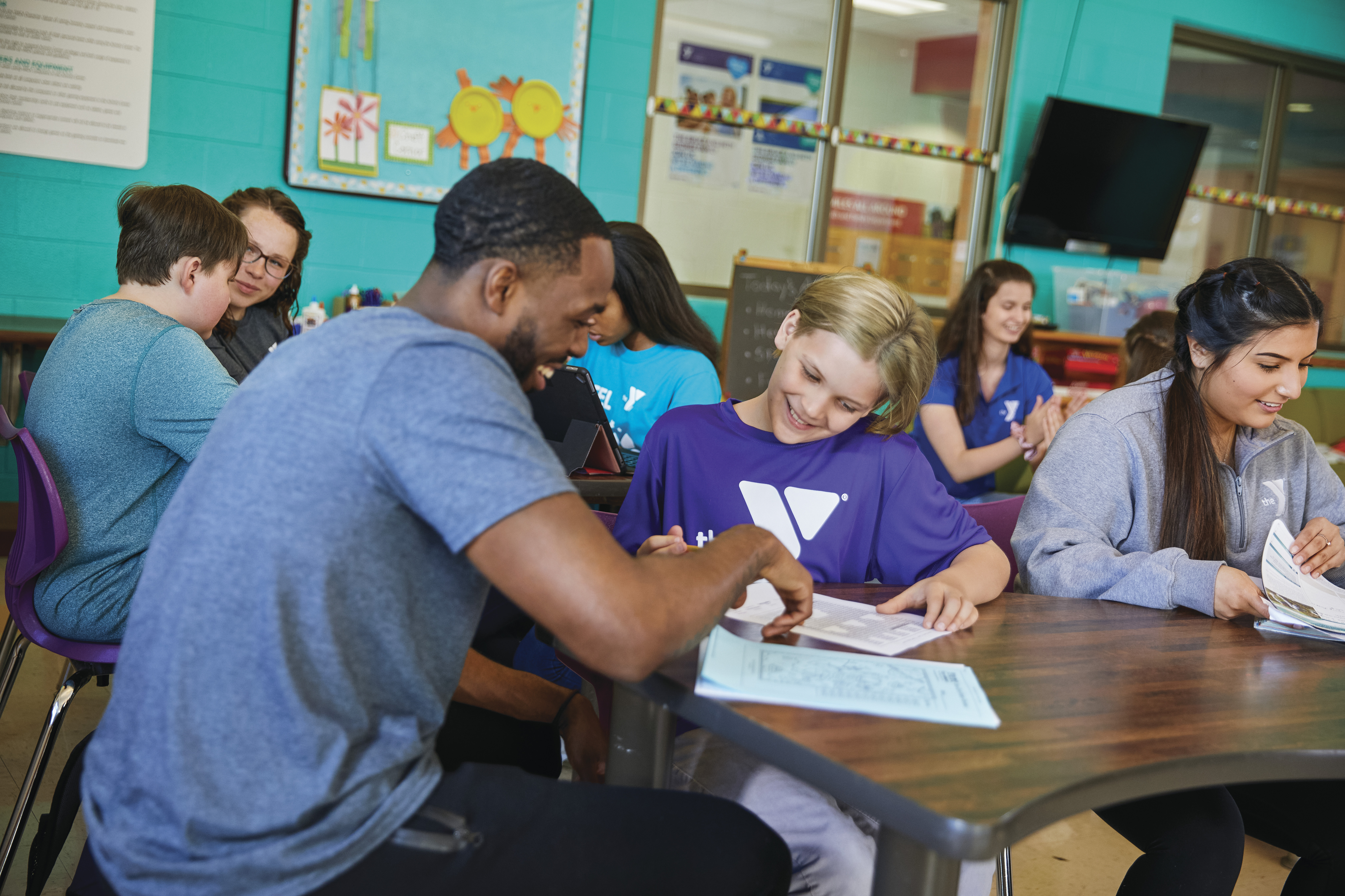 YMCA staff helping boy with homework